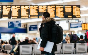 man_checking_departures_and_arrivals_board.tmb-1920v