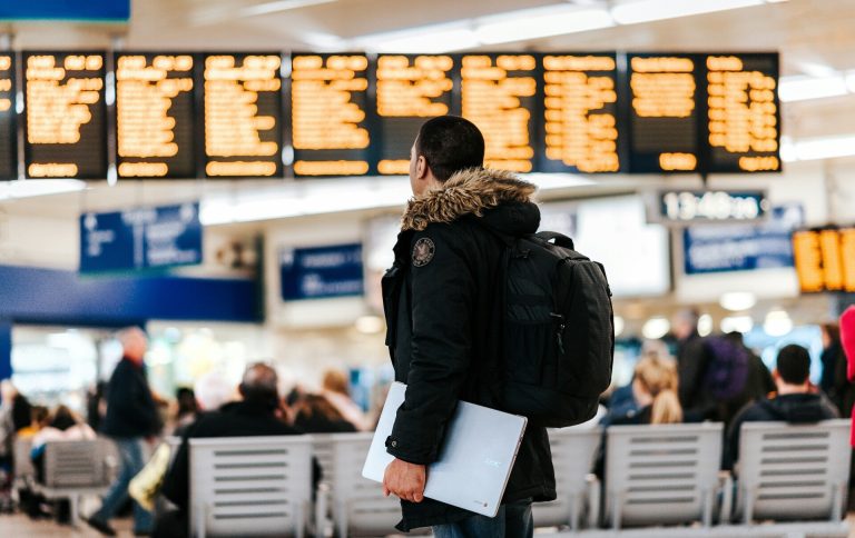 man_checking_departures_and_arrivals_board.tmb-1920v