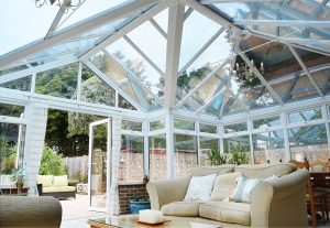 inside-view-of-a-luxury-white-conservatory-with-sofas-and-a-coffee-table