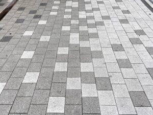 Sidewalk block with white and black bricks
