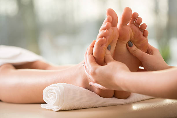Close-up of young woman having reflexology